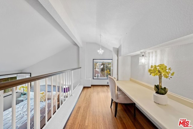 office featuring hardwood / wood-style flooring, vaulted ceiling with beams, and an inviting chandelier