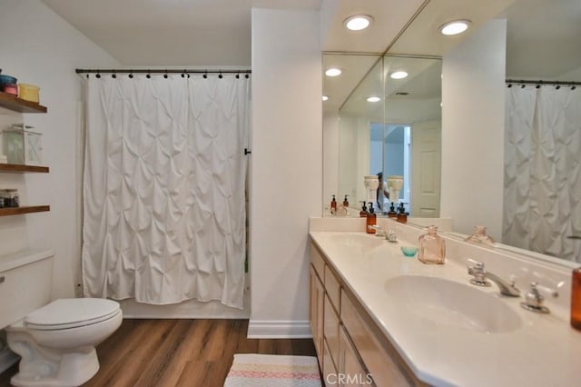 full bathroom with hardwood / wood-style flooring, shower / bath combo, vanity, and toilet