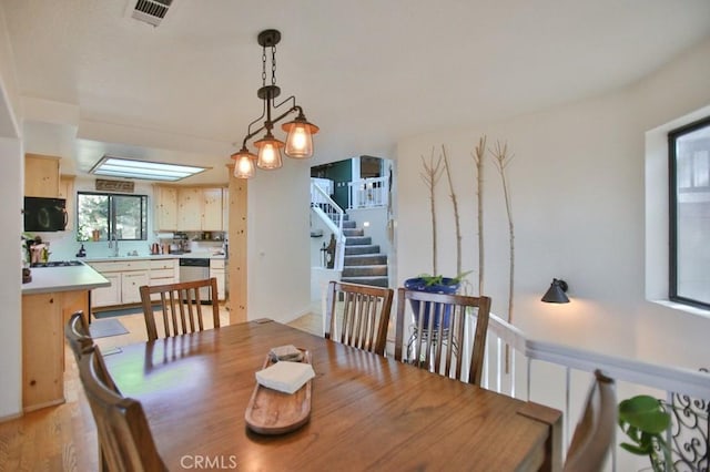 dining space featuring visible vents and stairs