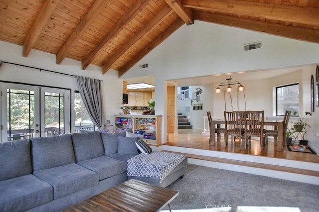 carpeted living room with french doors, wood ceiling, beam ceiling, and a wealth of natural light