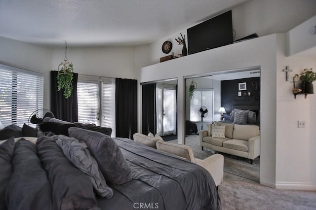 bedroom featuring carpet floors, baseboards, and two closets