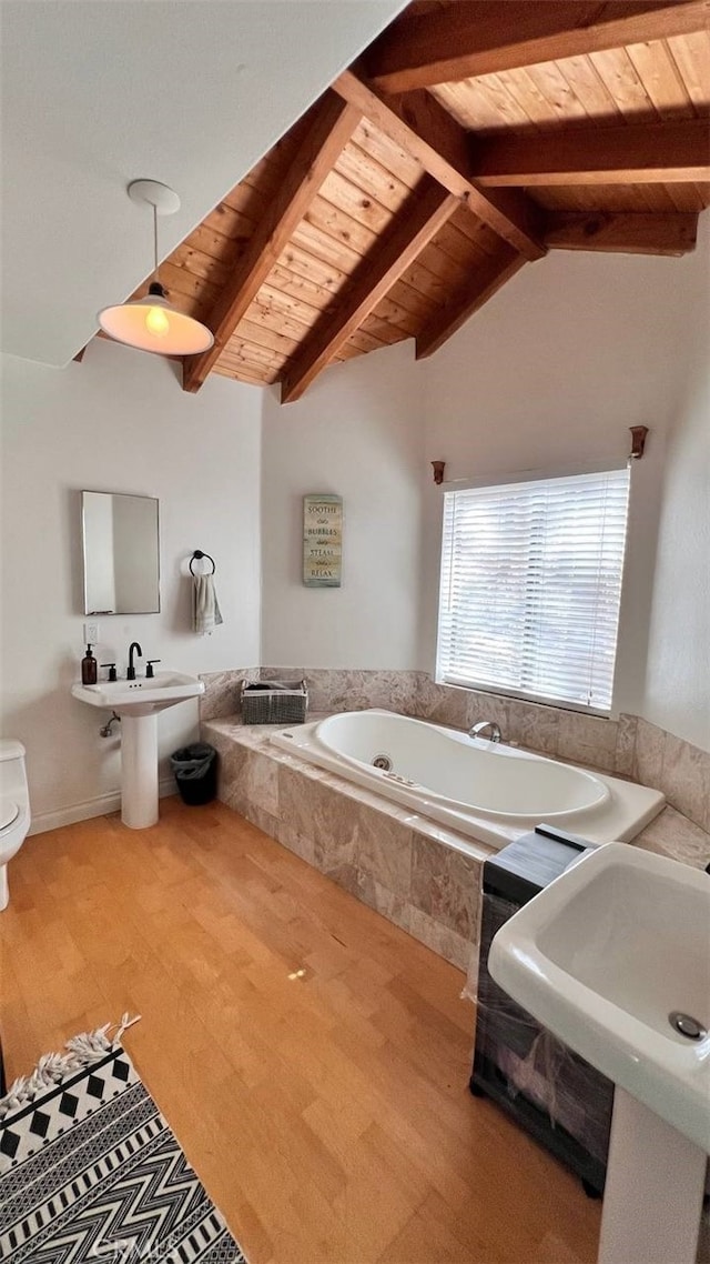 full bathroom with toilet, wooden ceiling, wood finished floors, vaulted ceiling with beams, and a garden tub