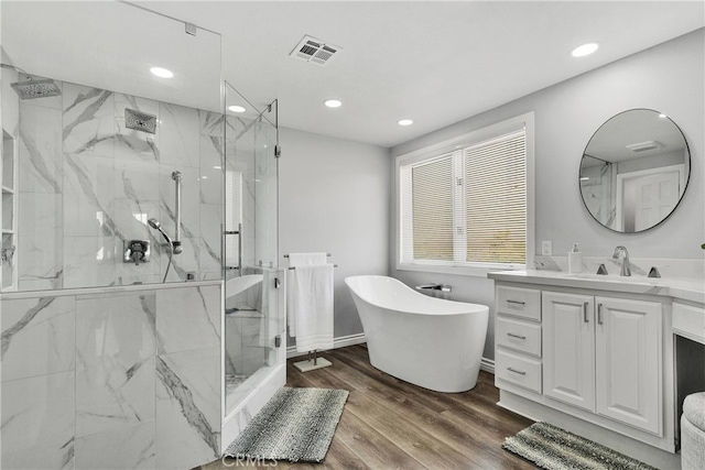 bathroom featuring vanity, shower with separate bathtub, and hardwood / wood-style flooring