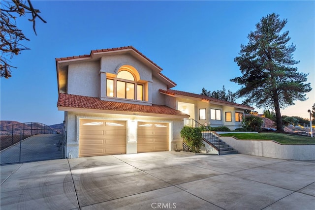 mediterranean / spanish house with a garage