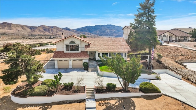 view of front of house with a mountain view and a garage