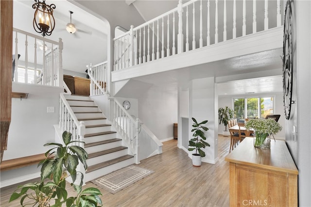 entryway with a towering ceiling and light hardwood / wood-style floors