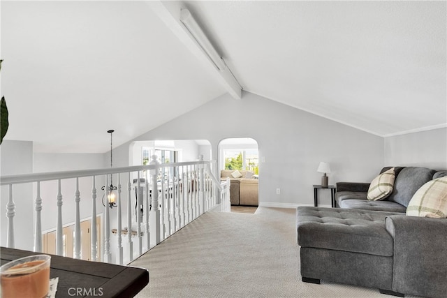 carpeted living room with lofted ceiling with beams