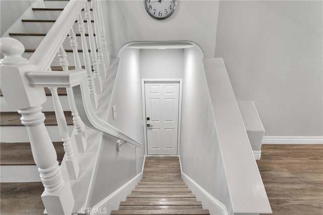 staircase featuring hardwood / wood-style flooring