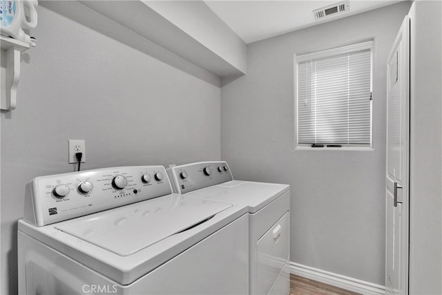 laundry area featuring light hardwood / wood-style flooring and washer and dryer