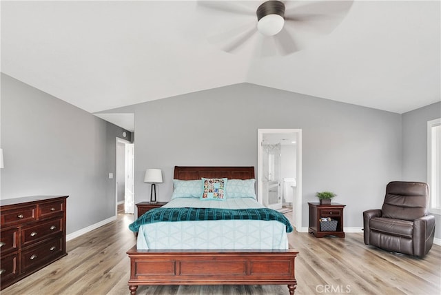 bedroom with ceiling fan, vaulted ceiling, light hardwood / wood-style flooring, and ensuite bath