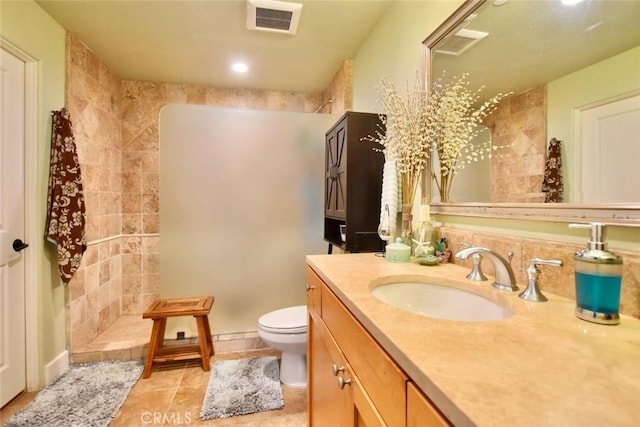 full bathroom featuring tile patterned floors, visible vents, toilet, walk in shower, and vanity