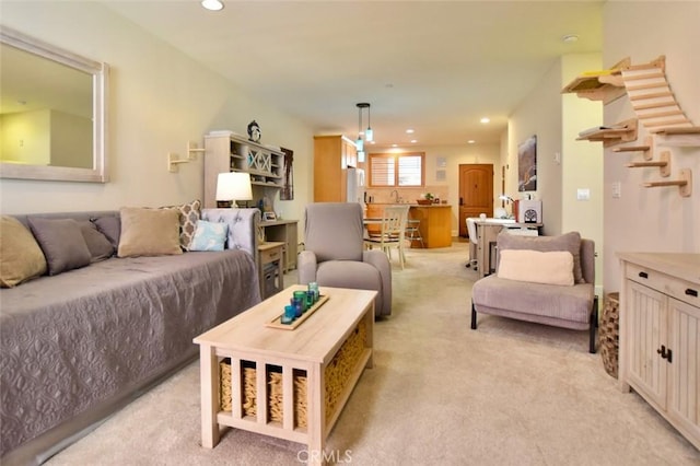 living area with recessed lighting and light carpet