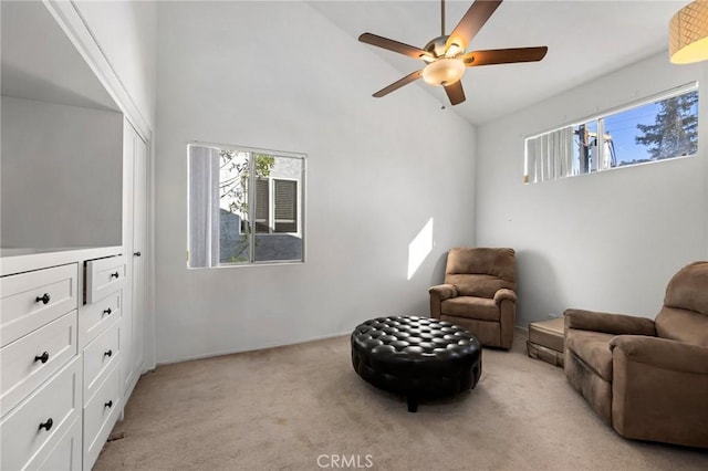 sitting room with light carpet, high vaulted ceiling, and ceiling fan