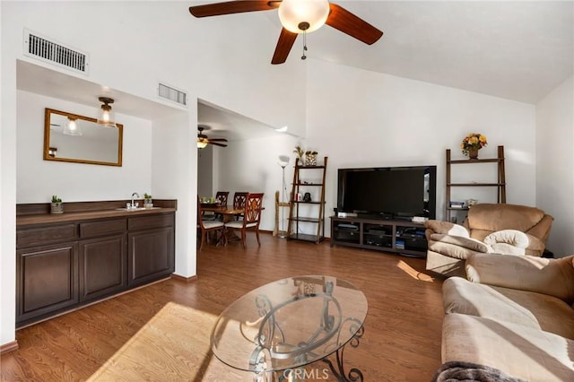 living room featuring dark hardwood / wood-style flooring and high vaulted ceiling