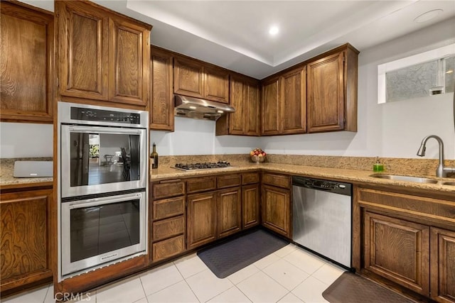 kitchen with light tile patterned flooring, appliances with stainless steel finishes, and sink