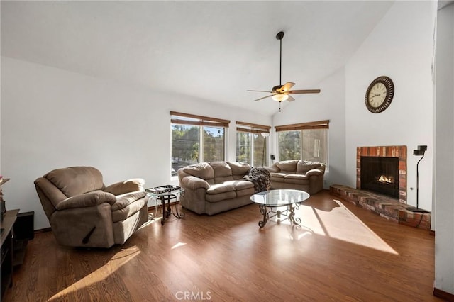 living room with dark hardwood / wood-style floors, ceiling fan, high vaulted ceiling, and a brick fireplace