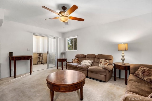 carpeted living room with ceiling fan