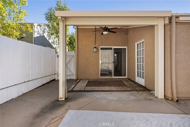 doorway to property with a patio and ceiling fan