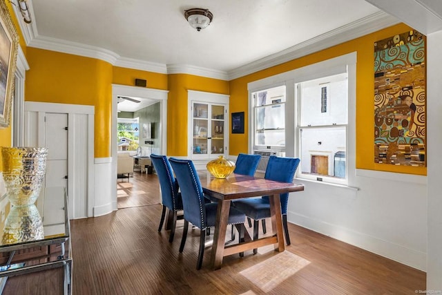 dining space with ornamental molding and hardwood / wood-style floors