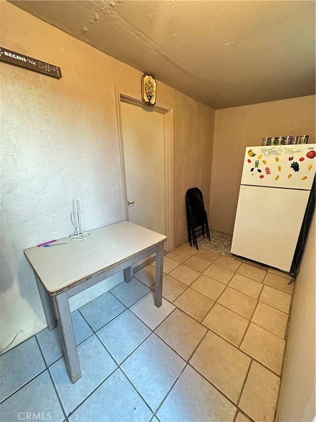 unfurnished dining area featuring tile patterned flooring