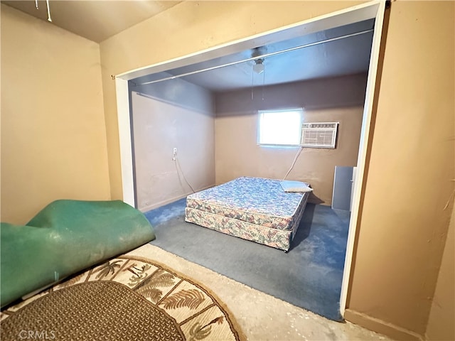 bedroom with a wall mounted AC and concrete floors