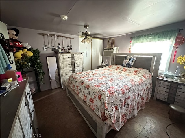 bedroom featuring ceiling fan and a wall unit AC