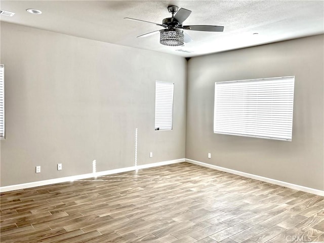 spare room with light hardwood / wood-style flooring and ceiling fan