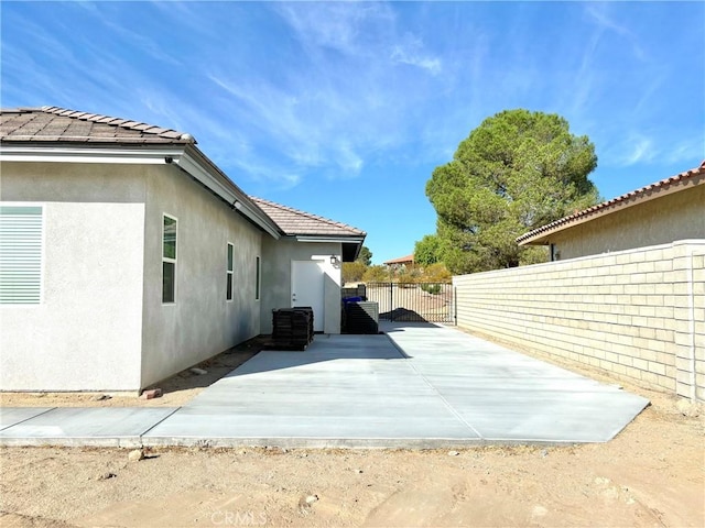 view of side of home featuring a patio area