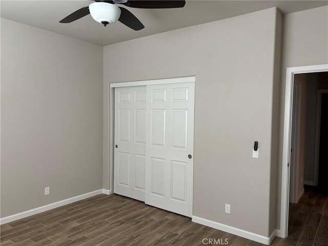 unfurnished bedroom featuring ceiling fan, dark hardwood / wood-style flooring, and a closet