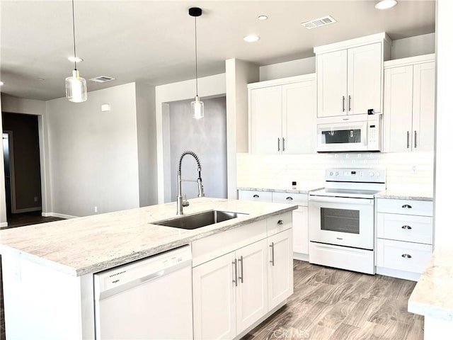 kitchen with sink, white cabinets, white appliances, and light hardwood / wood-style flooring