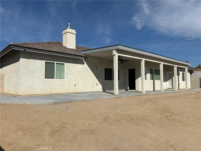 back of property featuring a patio and ceiling fan