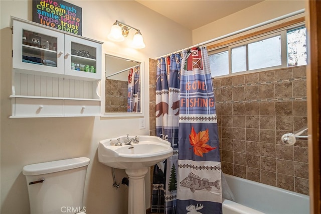 bathroom with shower / tub combo and toilet