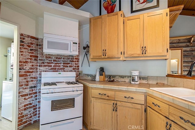 kitchen featuring wood ceiling, sink, white appliances, lofted ceiling with beams, and tile counters