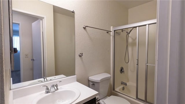 full bathroom with vanity, toilet, and enclosed tub / shower combo