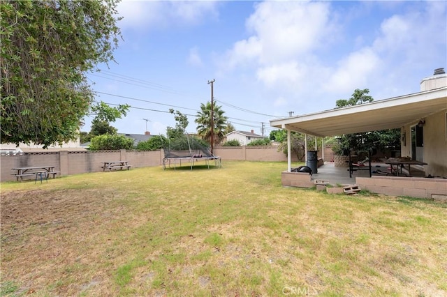 view of yard with a patio and a trampoline