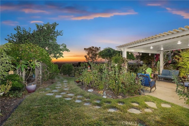 yard at dusk with a pergola and a patio