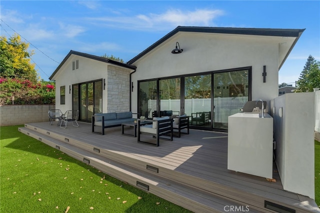 rear view of property with an outdoor hangout area and a deck