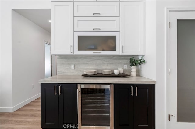 bar featuring white cabinets, decorative backsplash, and wine cooler