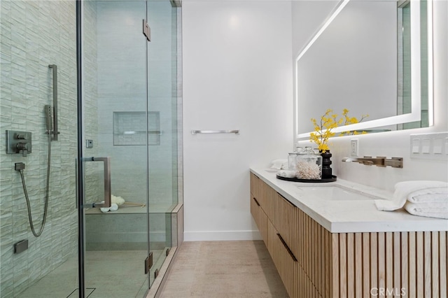 bathroom with vanity and a shower with shower door