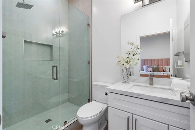 bathroom with vanity, toilet, and an enclosed shower