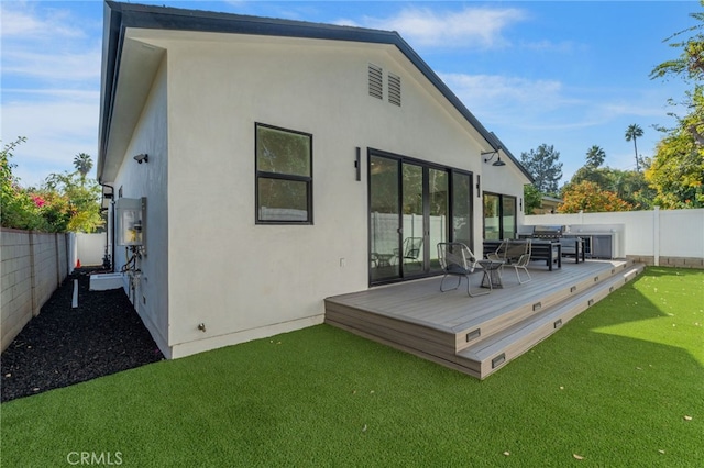 rear view of house featuring a deck