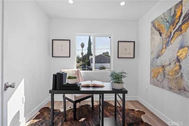 home office with hardwood / wood-style floors