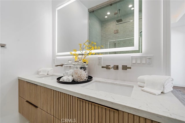 bathroom featuring vanity and an enclosed shower