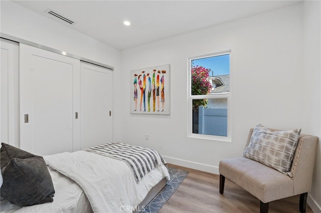 bedroom featuring hardwood / wood-style floors and a closet