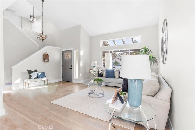 living room with hardwood / wood-style flooring and vaulted ceiling