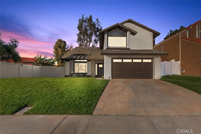 view of front facade with a yard and a garage