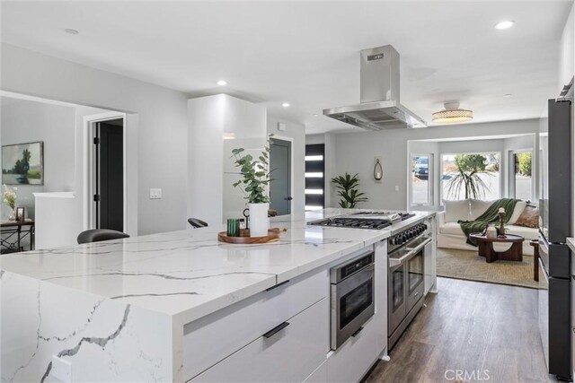 3078 Wilton Dr, Cambria, CA 93428 - kitchen featuring range hood, appliances with stainless steel finishes, modern cabinets, white cabinetry, and wood finished floors
