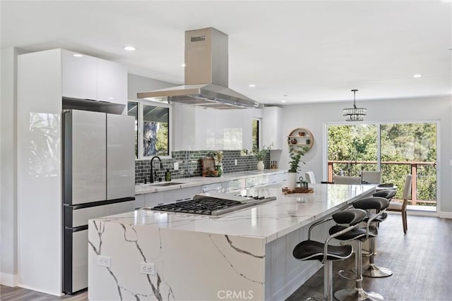 3078 Wilton Dr, Cambria, CA 93428 - kitchen with stainless steel appliances, island exhaust hood, a center island, white cabinetry, and modern cabinets