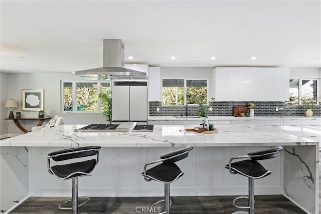 3078 Wilton Dr, Cambria, CA 93428 - kitchen featuring island exhaust hood, stainless steel gas cooktop, modern cabinets, refrigerator, and white cabinetry