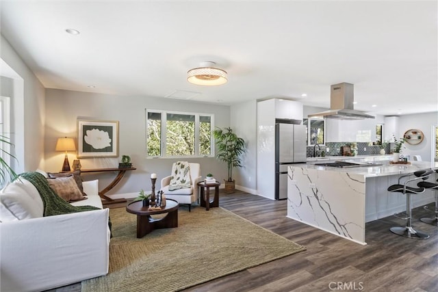 3078 Wilton Dr, Cambria, CA 93428 - kitchen with appliances with stainless steel finishes, island range hood, white cabinetry, a breakfast bar, and tasteful backsplash